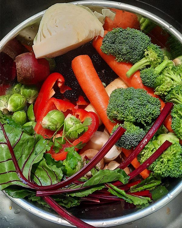 a large pot full of fresh vegetables
